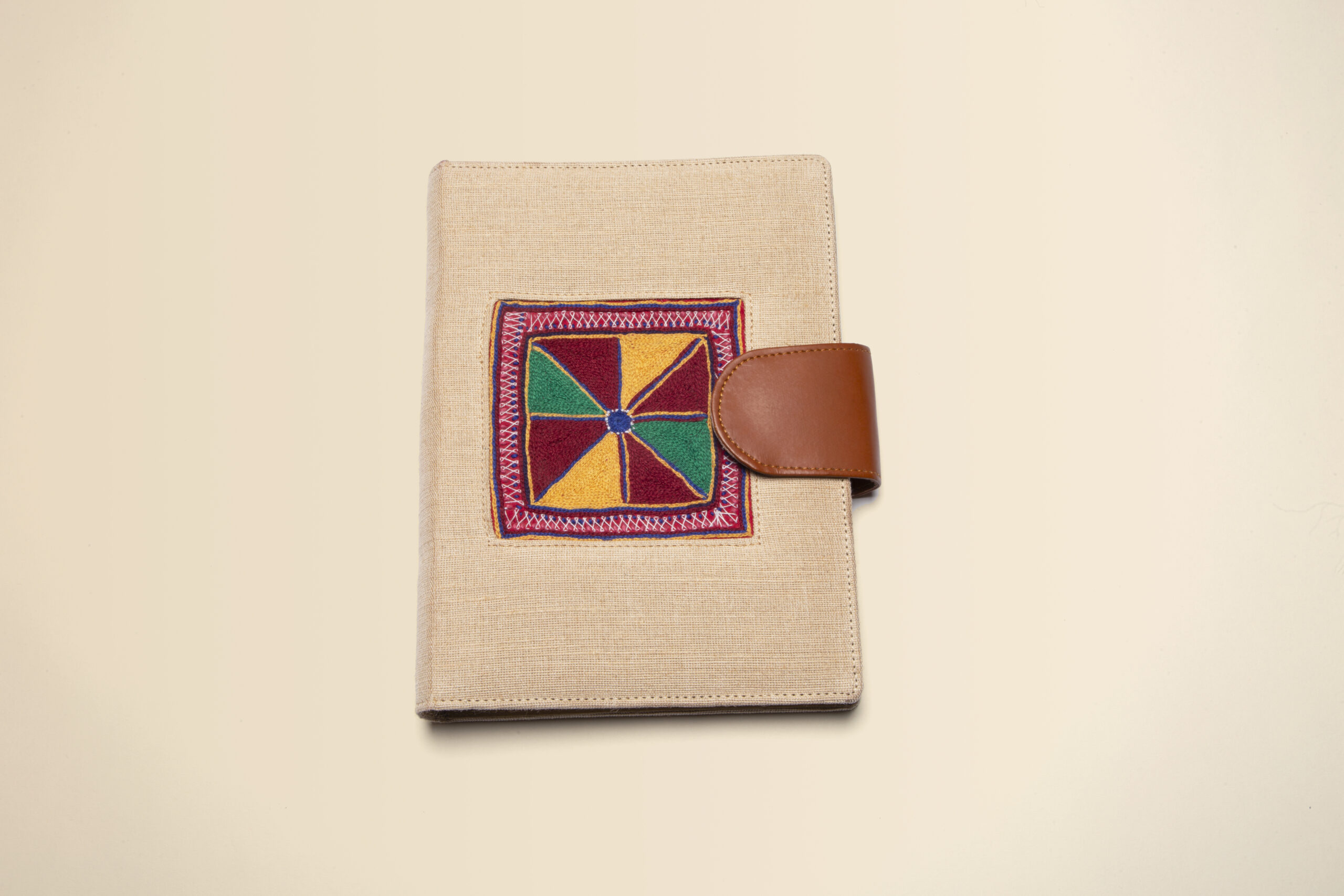 handcrafted linen diary with multicolor embroidered motif & leather closure handcrafted linen diary with multicolor embroidered motif & leather closure
