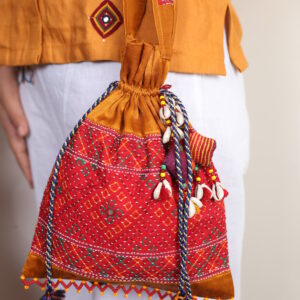 handcrafted mashroo silk embroidered potli bag with kutchi work & shell tassels