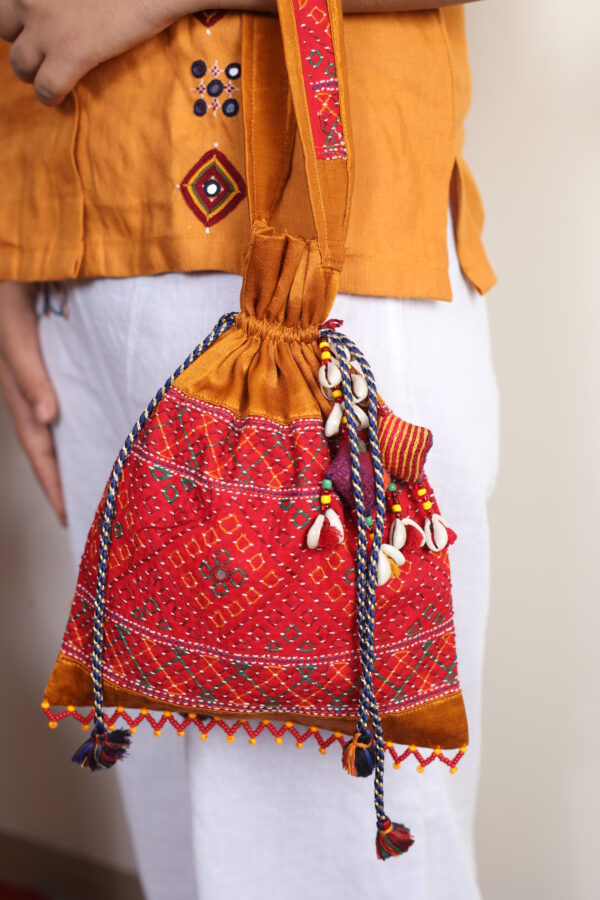 handcrafted mashroo silk embroidered potli bag with i work & shell tassels