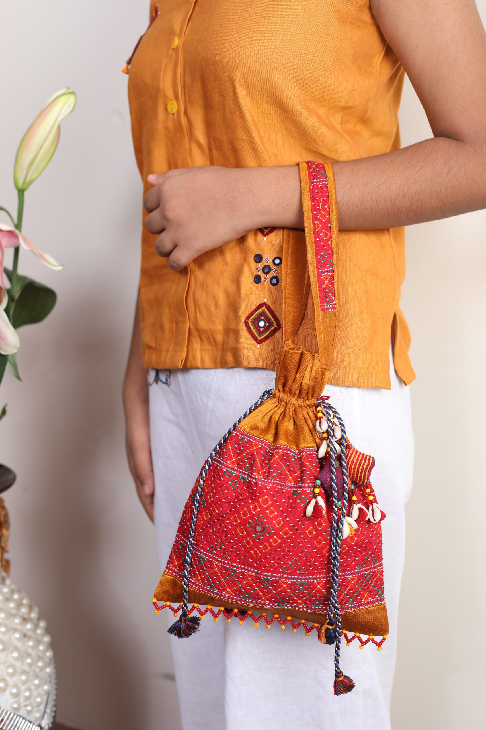 handcrafted mashroo silk embroidered potli bag with i work & shell tassels